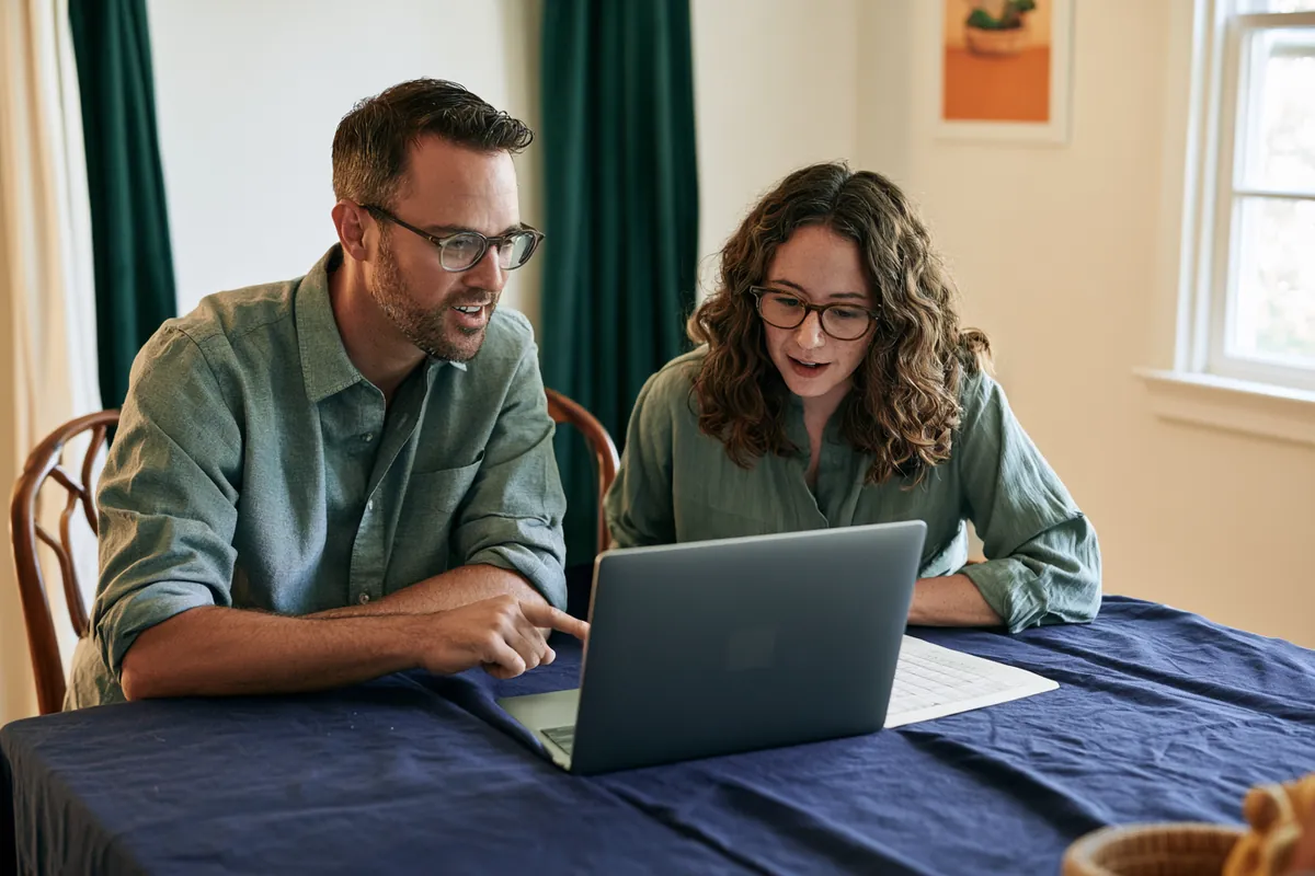 American man running the weighted-average consolidation calculation at his kitchen island
